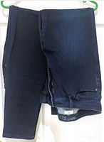 Pair of dark blue Parasuco jeans displayed folded