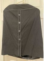 Size 16 black skirt with centre buttons and contrast stitching displayed hanging