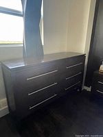 Front view of dresser showing six drawers and metal handles