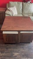 square wood coffee table with two stools tucked underneath