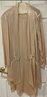 Beige shimmer dress with matching jacket on hanger