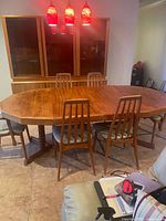 Full view showing teak dining hutch behind table