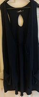 Black sleeveless vest with keyhole back and tie, size 14