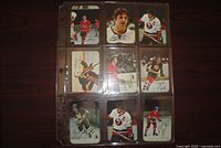 Fronts of nine 1977-78 Topps Star Glossy hockey cards in a nine-pocket page