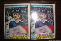 Front view of two identical Lanny McDonald Maple Leafs hockey cards