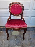 Front view showing red velvet upholstery, wood frame, cabriole legs