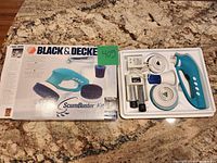 Box front and tray with scrubber and accessories displayed