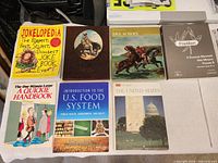 All eight books laid out front covers visible