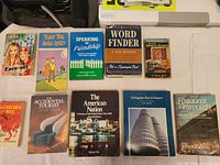 All ten paperback books laid out on white surface