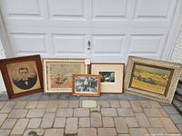 Group shot of all five framed pictures against garage door