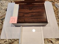 Frame in box showing woodgrain front with plastic cover