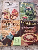 All four Better Homes and Gardens magazines arranged on surface displaying front covers