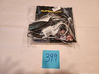 Front view of sealed SUPERNIGHT LED light kit in clear plastic bag