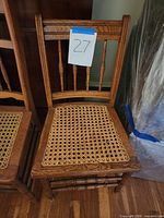 Front view of oak chair showing overall design and taped lot number