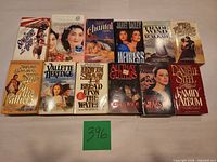 All 12 paperback books laid out in two rows