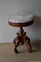 Full view of side table showing marble top and wooden pedestal base