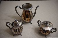 coffee pot, creamer, sugar bowl grouped on countertop
