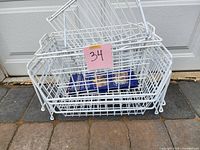 Stacked white wire baskets with lot number tag