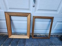 Front view of both wooden frames leaning against garage door