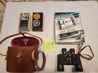 Group shot of radio with box and earphone, Wray binoculars with case, sealed Silver Shadow set
