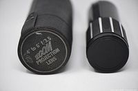 Lens and case side by side, case lid text visible