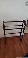 Full view of wooden towel rack standing indoors
