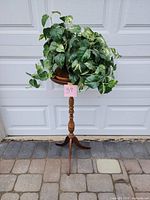 Full view of plant stand with artificial plant