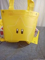 Front view of one yellow bag showing star graphic