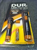 Front view of sealed Duracell LED flashlights package showing both flashlights and battery