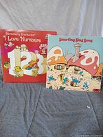 Front view of both record sleeves standing upright