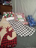 Overall lot showing tree skirt, stocking, ornaments, pom poms, treat bags