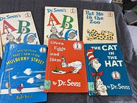 All six hardcover children’s books laid out front covers visible