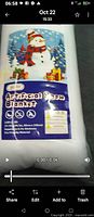 Front of sealed artificial snow blanket package showing product name and graphics