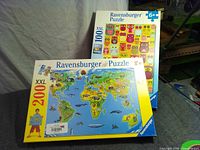 Front view of both Ravensburger puzzle boxes showing titles, piece counts and age ranges