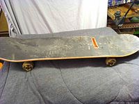 Top view of complete skateboard showing grip tape and deck wear