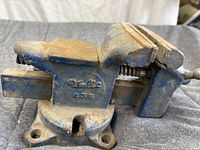 Left side view of blue cast-iron bench vise showing brand/model 435 and mounting base