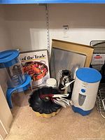 Group view showing pitchers, iced tea maker, Bundt pan, utensils, carafe, canister, baking sheets