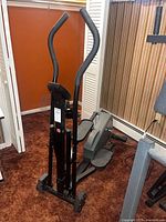 Full view of elliptical trainer with handlebars and pedals