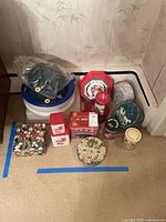 Group view of plastic containers and assorted holiday tins