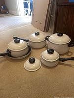 Group shot of all pots, pans and lids