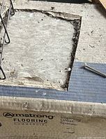 Armstrong Flooring Commercial box with gray concrete-look tile visible