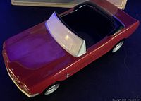 Top view showing red ceramic body, white windshield, black interior