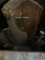 Carved cross cutout on pew end panel