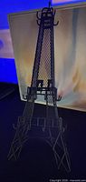 Front view of black metal Eiffel Tower jewelry holder