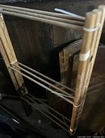 Full view of folding wooden rack leaning against wall
