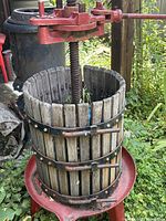 Full view of wooden stave basket, steel bands, cast-iron screw and red base