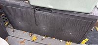 Front view of Keter resin rattan deck storage box showing woven pattern and latch