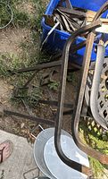 Pair of metal table legs lying outdoors showing shape and finish