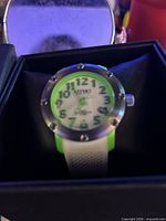 Watch in presentation box showing dial, bezel, strap colors