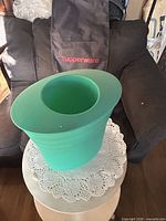 Front view of green container mistakenly shown; background shows Tupperware bag (not part of described lot)